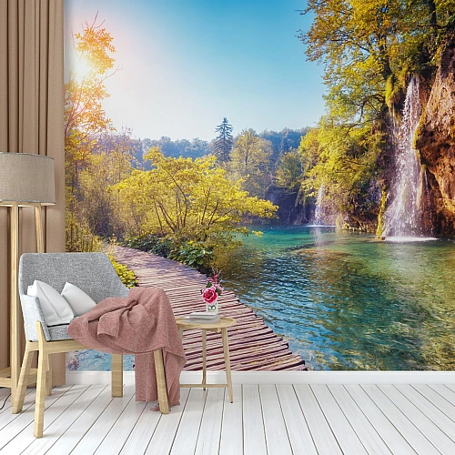 Sunlit Waterfall Lake Path Wall Mural – Scenic Nature Walkway Wallpaper for Living Room